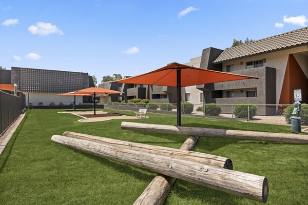 Outdoor recreational area featuring lush greenery at Highland Park Apartments
