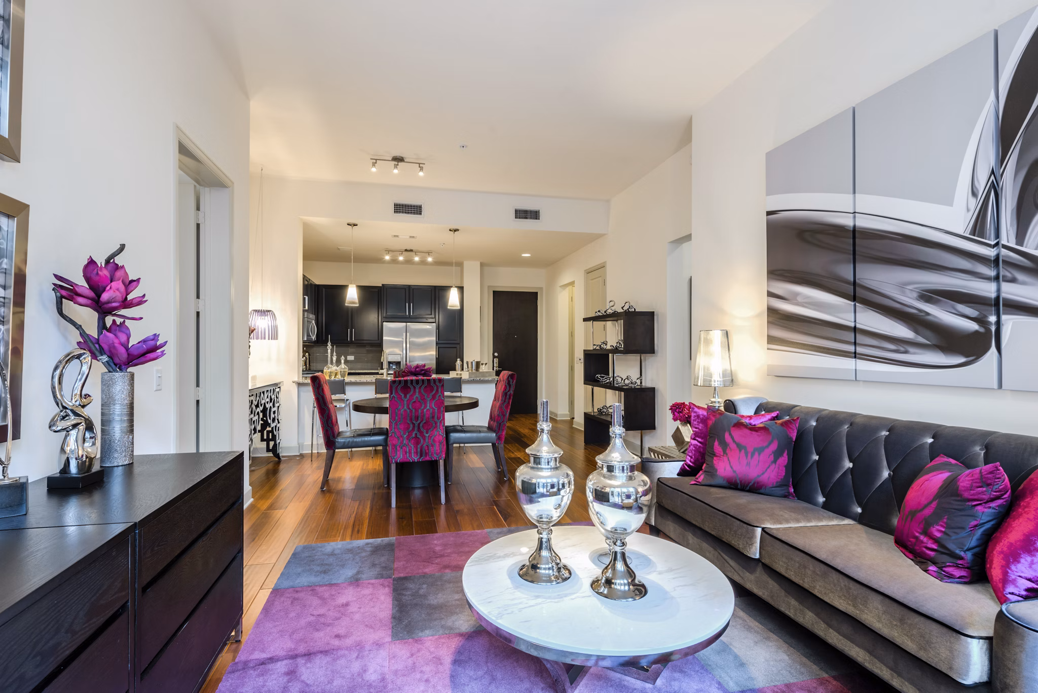 Spacious living room with elegant furnishings and large windows at WaterWall Place Luxury Apartments