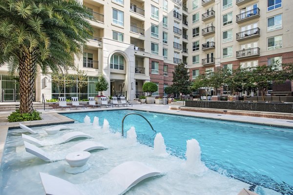 Pool area with cabanas and lounge chairs at WaterWall Place Luxury Apartments in Houston, showcasing luxury living amenities for residents