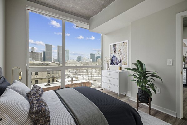 Cozy bedroom with modern furnishings at The Granary Apartments: Luxury living by Greystar