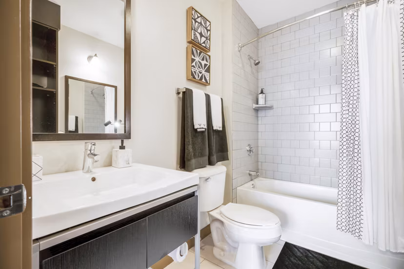 The Granary Apartments: Modern bathroom with sleek fixtures and large mirror