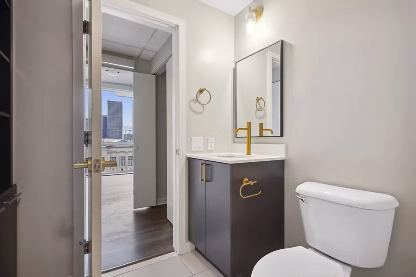 Elegant bathroom with marble countertops and modern fixtures in The Granary Apartments