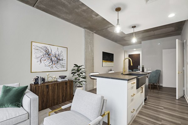 Chic kitchen with marble countertops and modern fixtures in The Granary Apartments