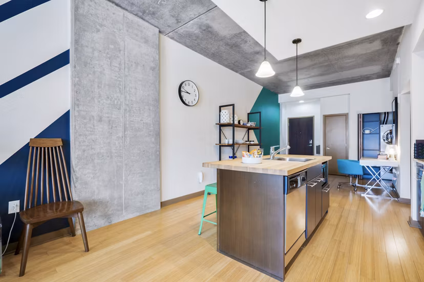 Modern kitchen with stainless steel appliances and sleek cabinetry at The Granary Apartments