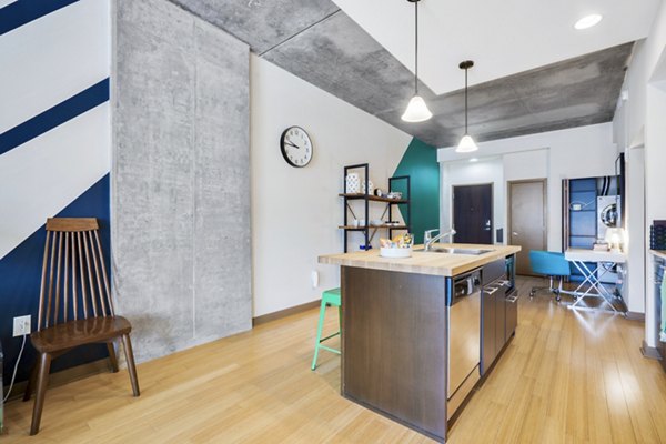 Modern kitchen with stainless steel appliances and sleek cabinetry at The Granary Apartments