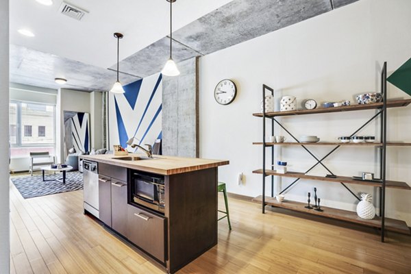 Contemporary kitchen with stainless steel appliances at The Granary Apartments, offering luxury living in a vibrant community