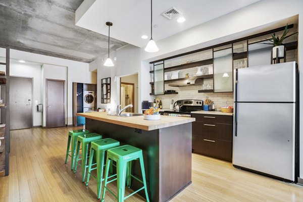 Modern kitchen with stainless steel appliances at The Granary Apartments, a luxury Greystar property