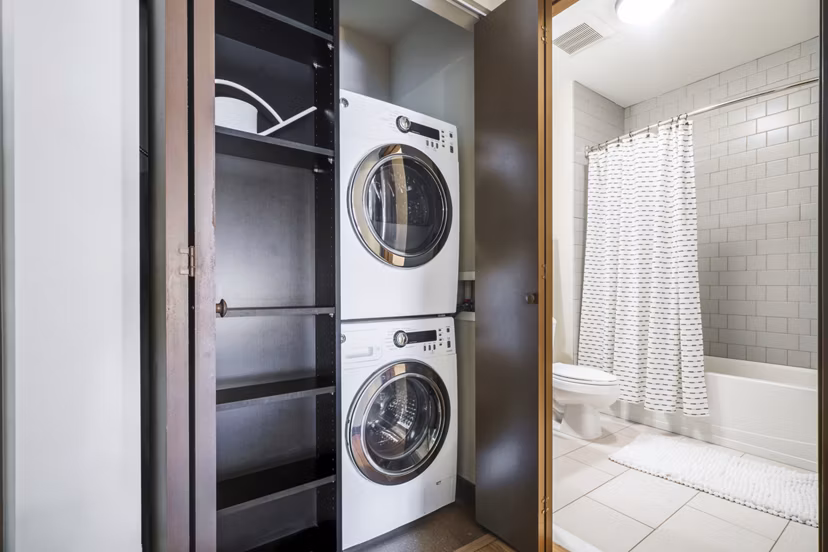 Boutique bath and laundry room with modern fixtures at The Granary Apartments, providing convenience and style for luxury living