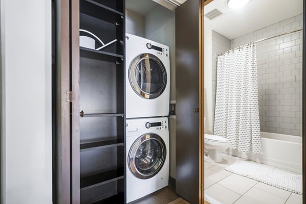 Boutique bath and laundry room with modern fixtures at The Granary Apartments, providing convenience and style for luxury living