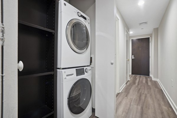 Laundry room featuring modern appliances at Drexler Townhomes, luxury apartments at Holbrook Farms