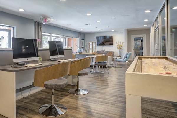 Business center with modern workstations at Park Kiely Apartments, offering a productive environment for residents looking for luxury apartments