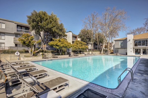 Elegant pool area with lounge chairs at Park Kiely Apartments, ideal for relaxation and gatherings