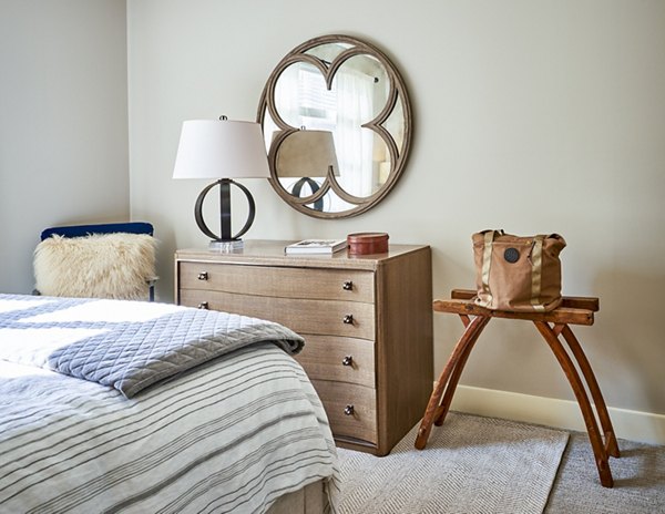 Bedroom with contemporary decor and large windows in Solis SouthPark Apartments