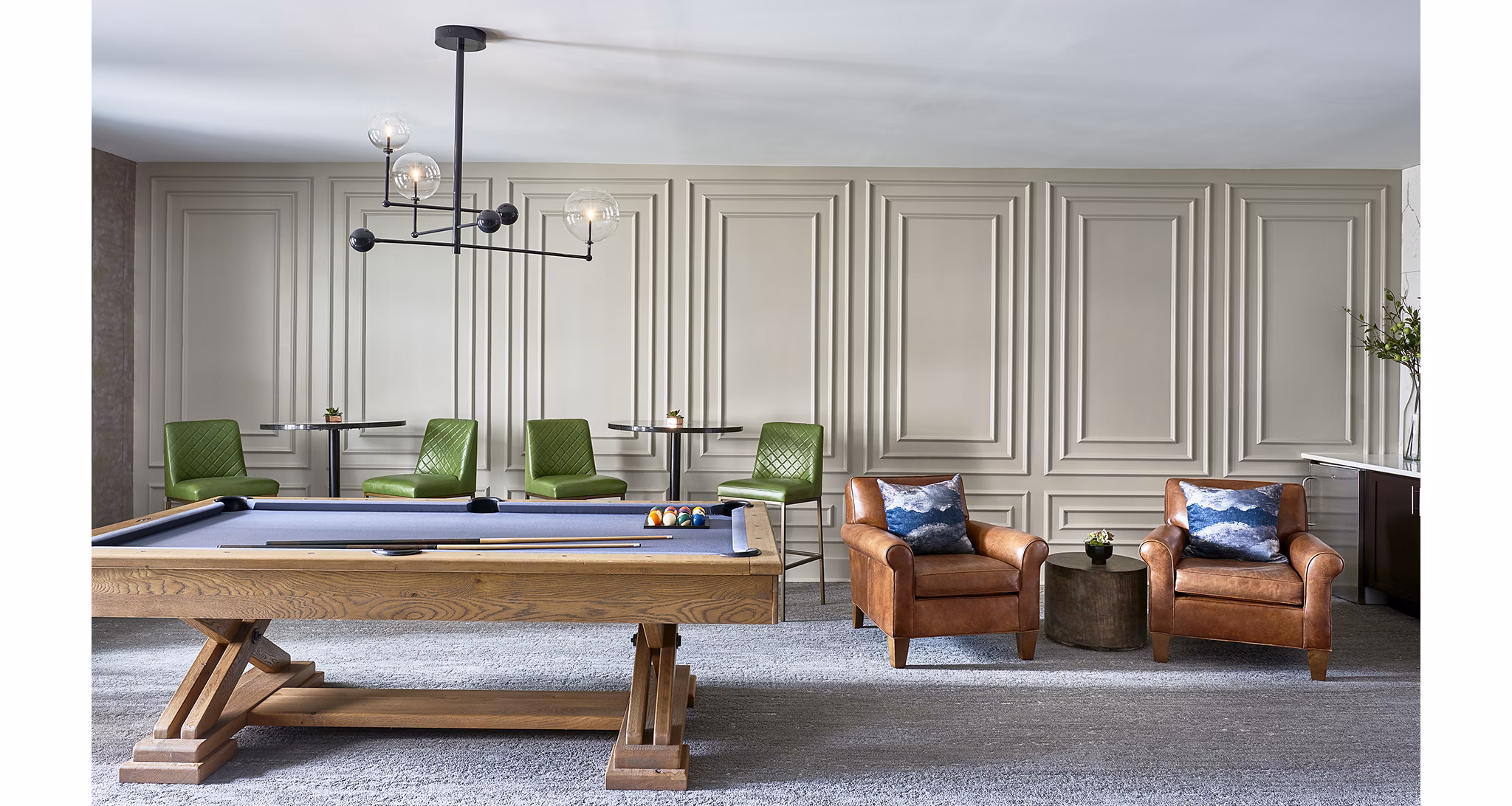 Game room featuring pool tables and lounge seating at Solis SouthPark Apartments in a luxury setting