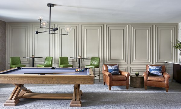 Game room featuring pool tables and lounge seating at Solis SouthPark Apartments in a luxury setting