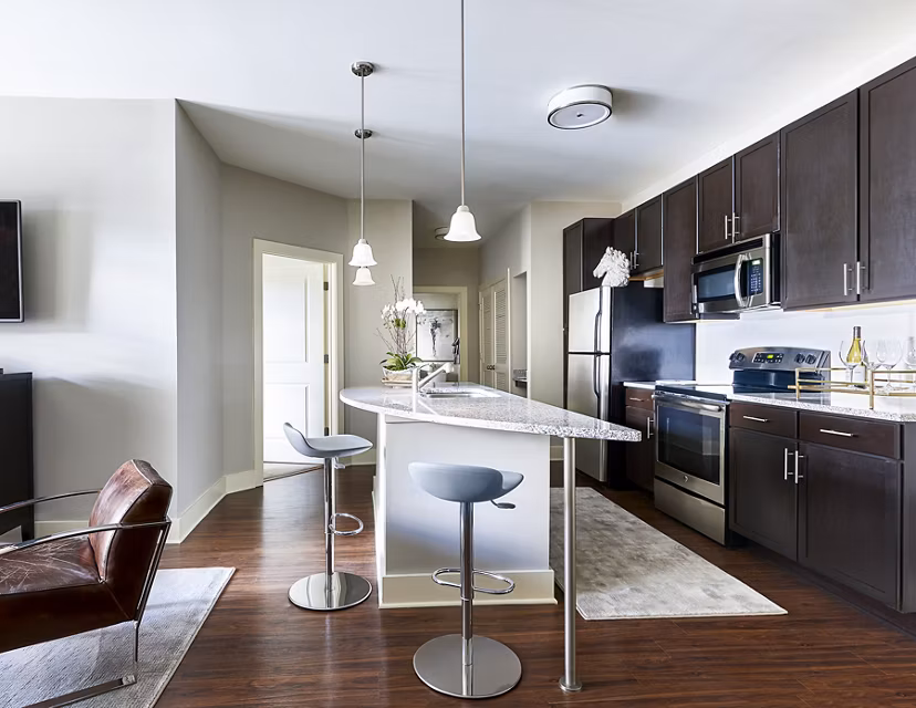 Modern kitchen with stainless steel appliances at Solis SouthPark Apartments