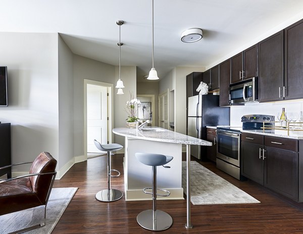 Modern kitchen with stainless steel appliances at Solis SouthPark Apartments