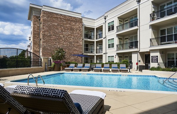 Luxurious outdoor pool area with modern lounge seating at Solis SouthPark Apartments