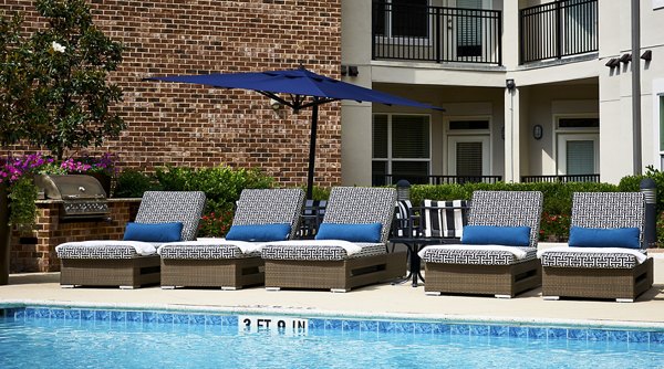 â€œStylish pool surrounded by loungers at Solis SouthPark Apartmentsâ€