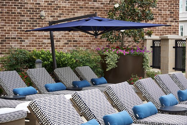 Resort-style pool patio with lounge seating at Solis SouthPark Apartments, perfect for relaxation and social gatherings