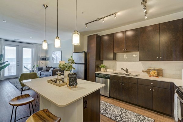 Modern kitchen with sleek countertops and stainless steel appliances at Burnet Flats Luxury Apartments