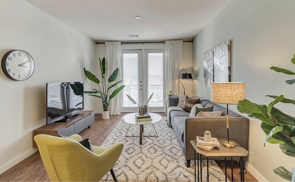 Spacious living room with modern decor at Burnet Flats Luxury Apartments