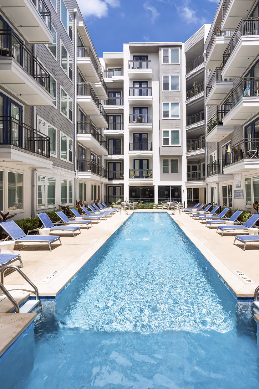 Rooftop pool with lounge chairs and skyline views at Burnet Flats Luxury Apartments