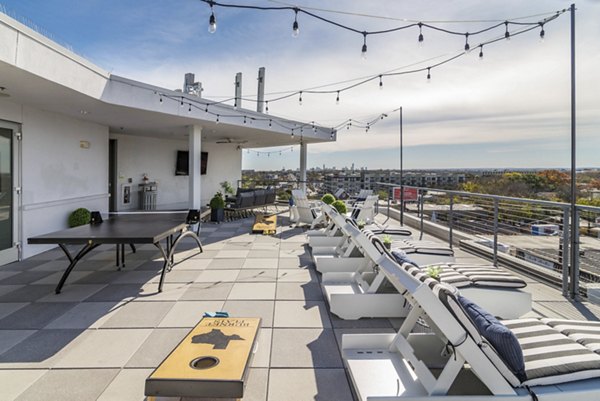 Rooftop deck with lounge seating at Burnet Flats Luxury Apartments offering panoramic cityscape views