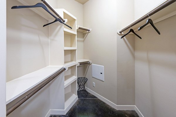 Walk-in closet with ample shelving at Elan Med Center Apartments, a luxury living space near Texas Medical Center in Houston