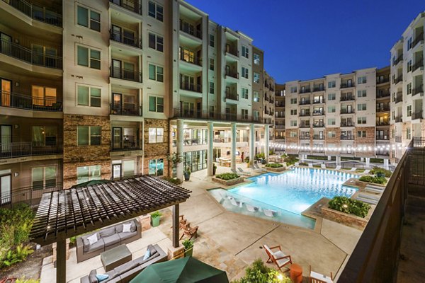 Modern pool area with stylish lounge chairs at Elan Med Center Apartments in Houston