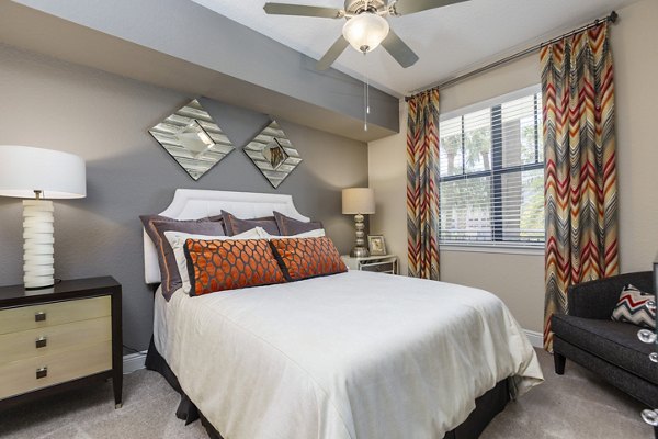 Elegant bedroom with modern furnishings in 2 Bayshore Apartments, showcasing luxury living in a serene environment