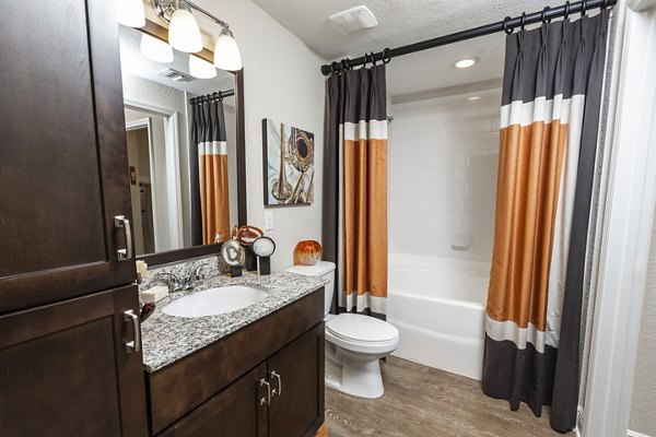 Modern bathroom with marble countertops at 2 Bayshore Apartments