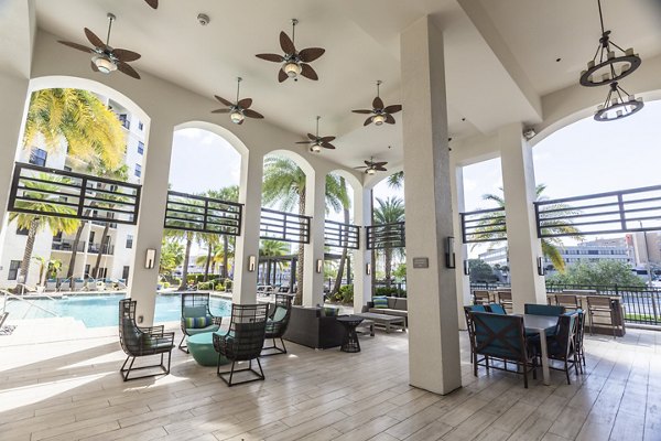 Outdoor patio with stylish seating at 2 Bayshore Apartments, offering a luxurious living experience near the waterfront