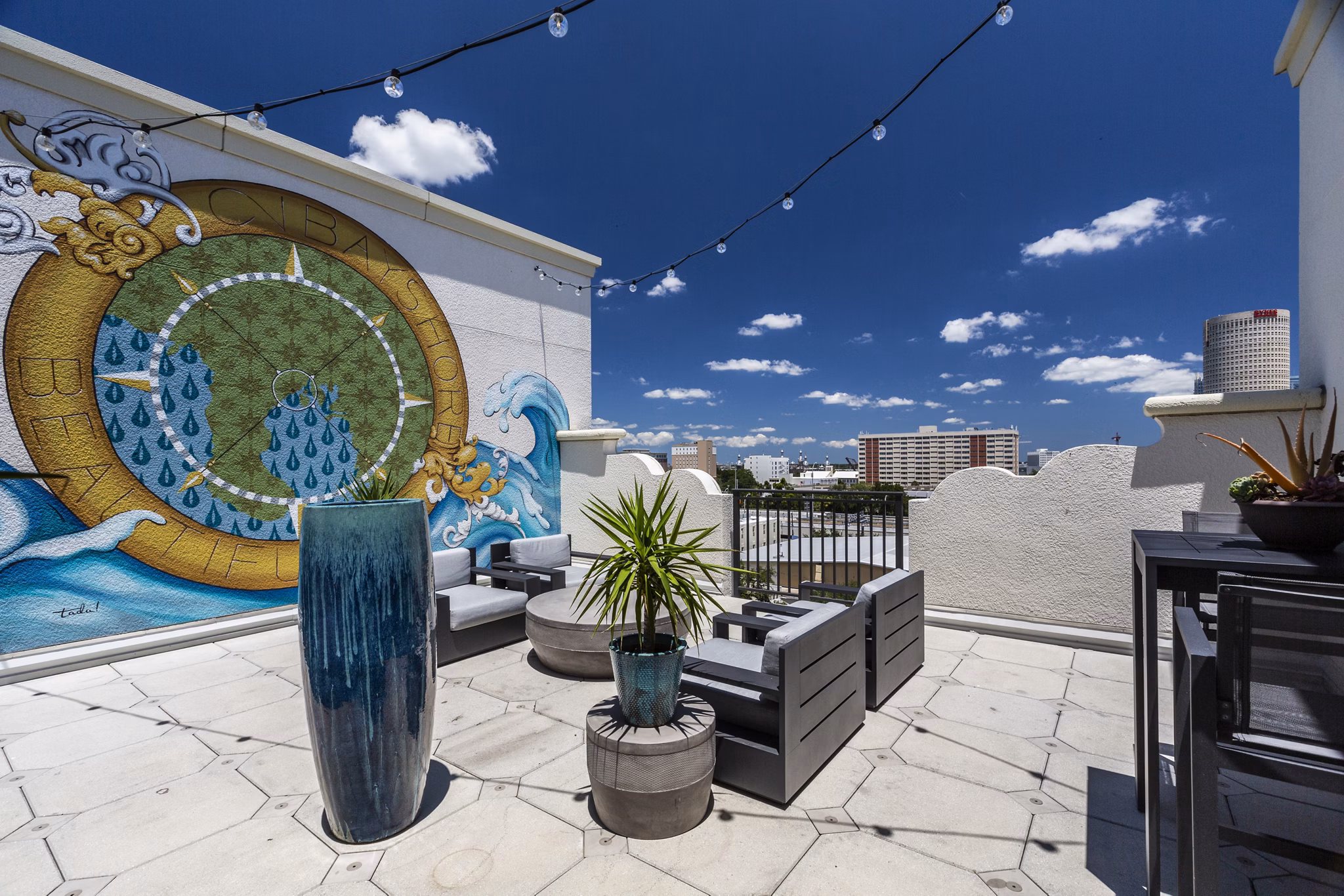 Rooftop deck with lounge seating and stunning city views at 2 Bayshore Apartments