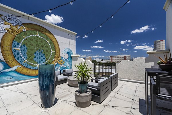 Rooftop deck with lounge seating and stunning city views at 2 Bayshore Apartments