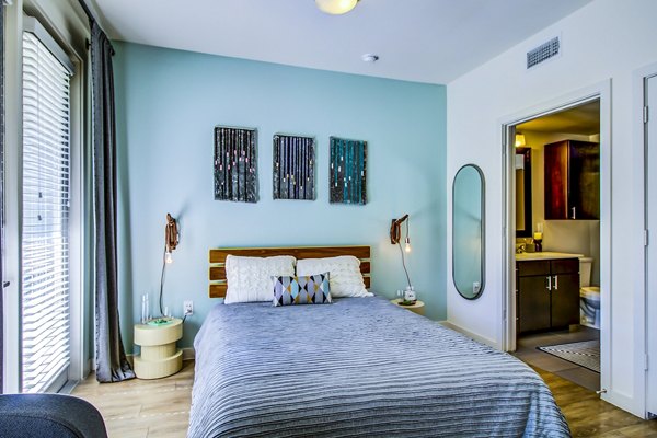 Cozy bedroom with modern decor and natural light at Elan East Apartments
