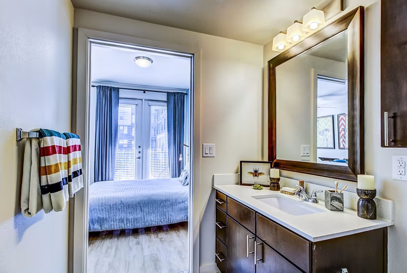 Modern bathroom with sleek fixtures at Elan East Apartments featuring marble countertops and spacious layout