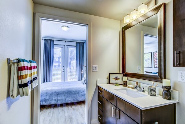 Modern bathroom with sleek fixtures at Elan East Apartments featuring marble countertops and spacious layout