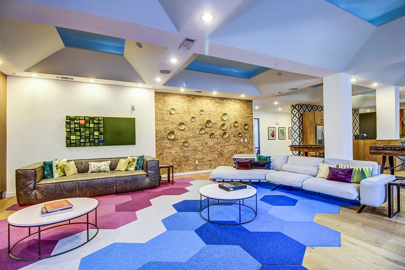 Clubhouse lobby featuring modern design and lounge seating at Elan East Apartments