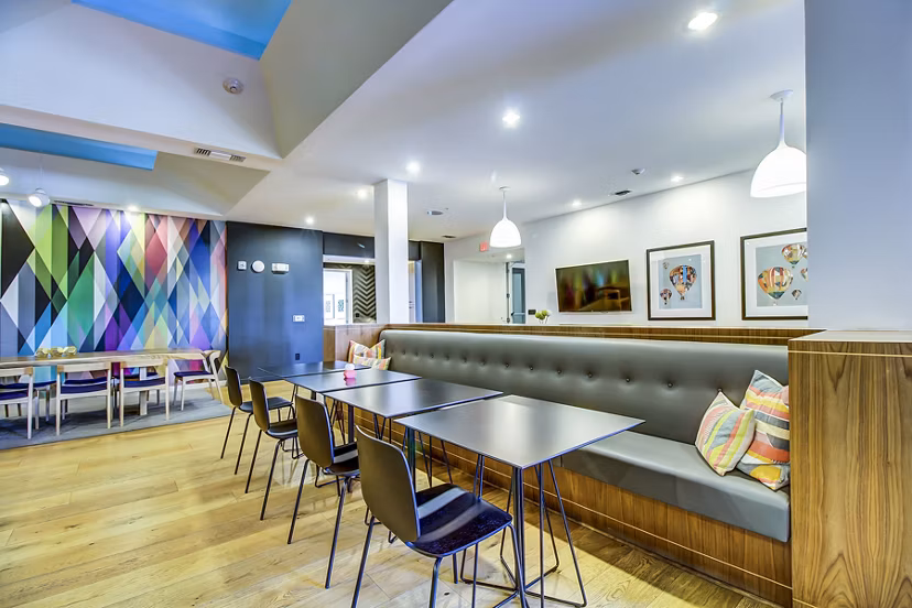 Clubhouse lobby with modern seating and vibrant decor at Elan East Apartments in Austin, TX
