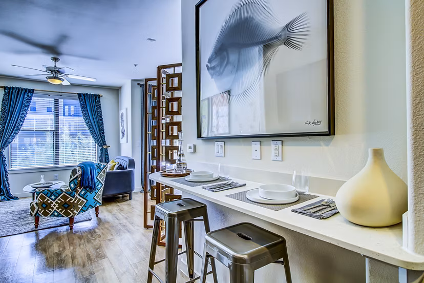 Dining room with sleek modern decor at Elan East Apartments, showcasing luxury living in a contemporary setting