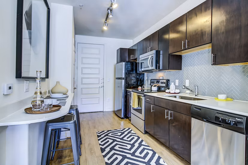 Modern kitchen with stainless steel appliances at Elan East Apartments