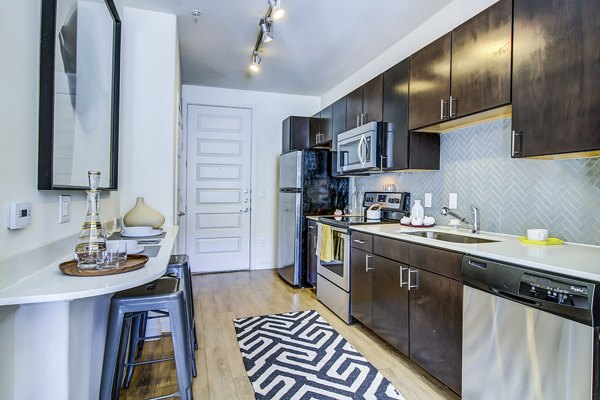 Modern kitchen with stainless steel appliances at Elan East Apartments