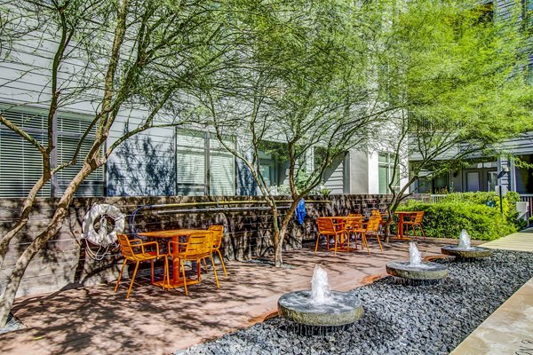 Tranquil courtyard patio with lush landscaping at Elan East Apartments, ideal for relaxation in a charming setting