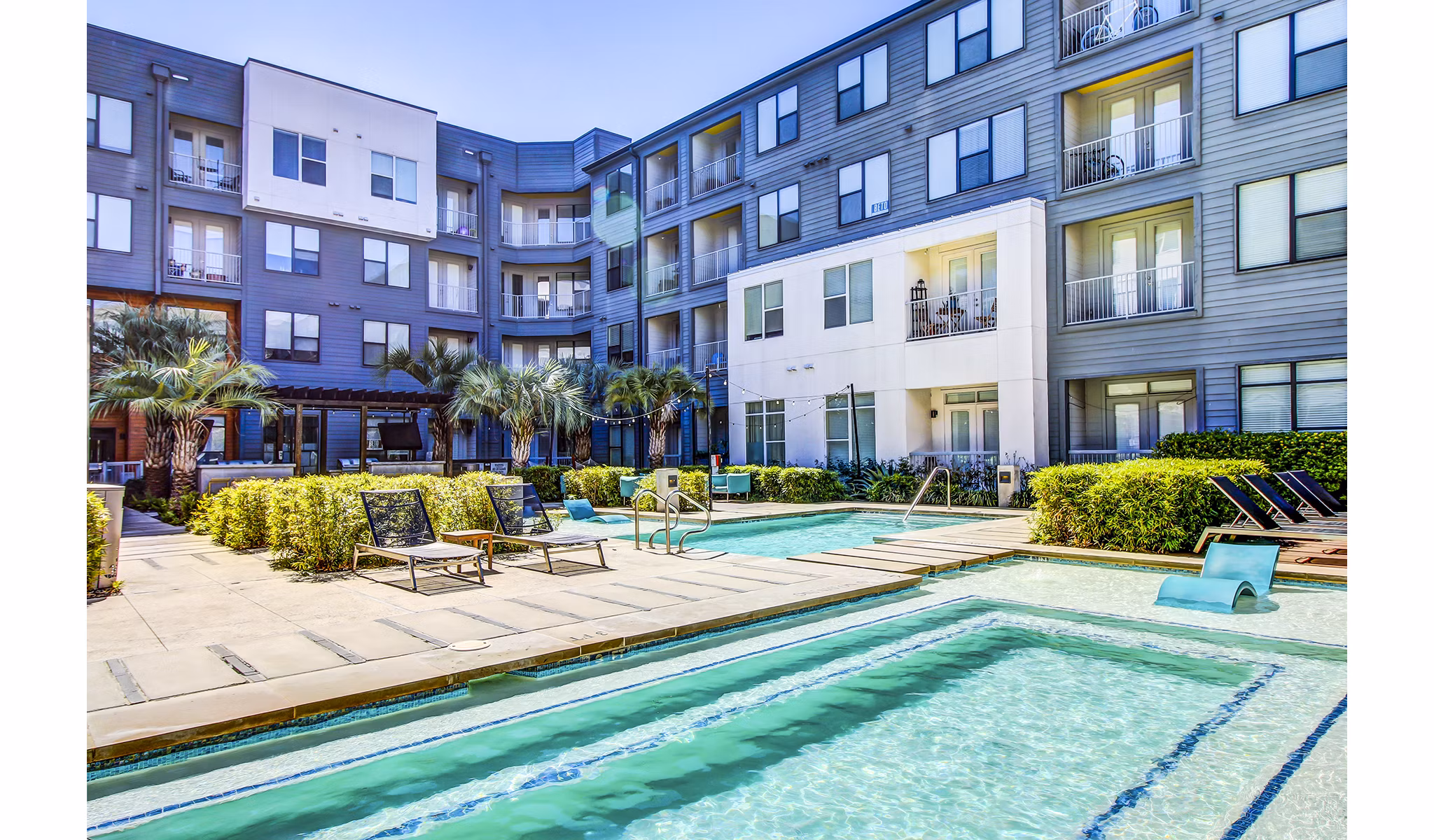 Inviting outdoor pool with lounge chairs at Elan East Apartments, perfect for relaxation and leisure activities in Austin