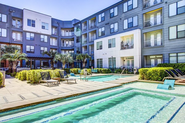 Inviting outdoor pool with lounge chairs at Elan East Apartments, perfect for relaxation and leisure activities in Austin
