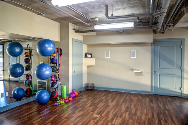 Fully-equipped fitness center with modern gym equipment at Coldwater Luxury Apartments