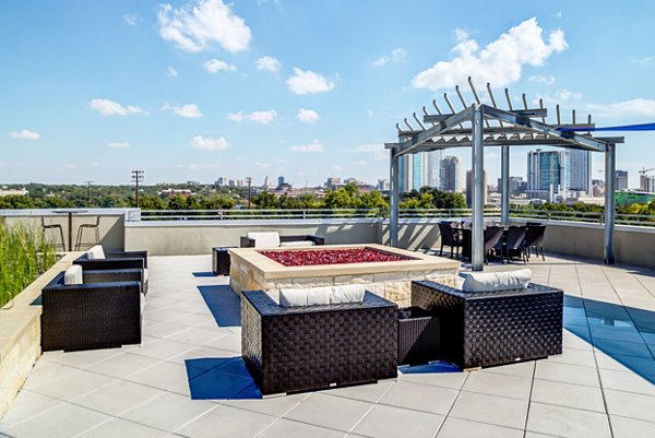 Outdoor fire pit gathering area at Coldwater Luxury Apartments