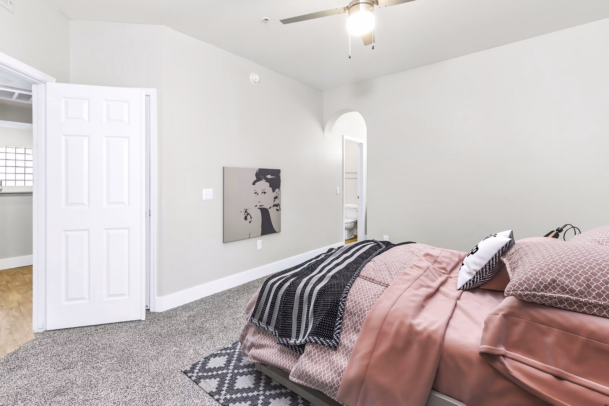 Cozy bedroom featuring stylish decor and large windows at Fountain Palms Apartments