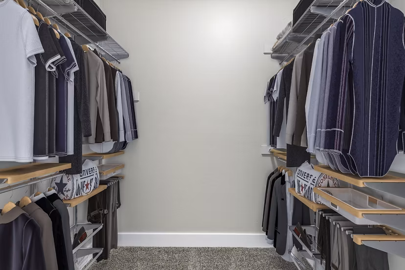 Modern bedroom closet with sliding doors at Fountain Palms Apartments, featuring ample storage space and sleek design